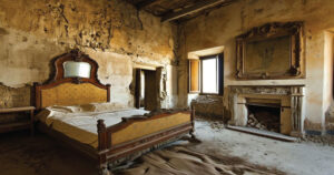 A rustic, abandoned bedroom with a decaying bed, aged fireplace, and peeling walls, illuminated by sunlight from an open window.
